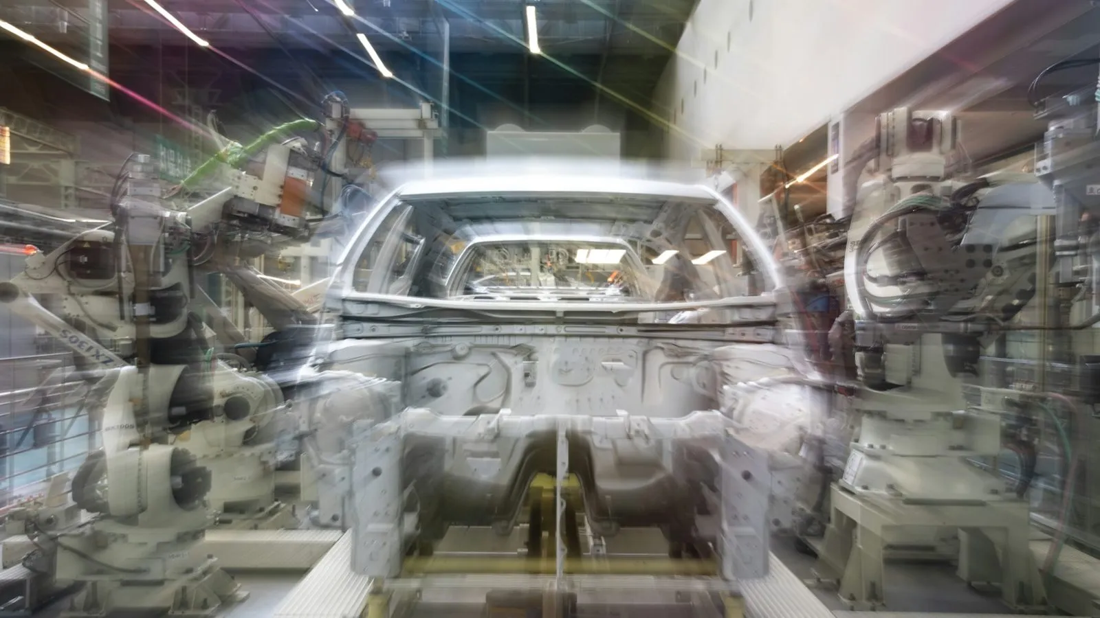 Robotic arms welding a car body on an automotive assembly line